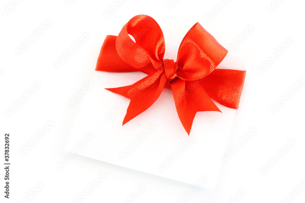 Sheet with red holiday bow on white background Sheet with red holiday bow on white background