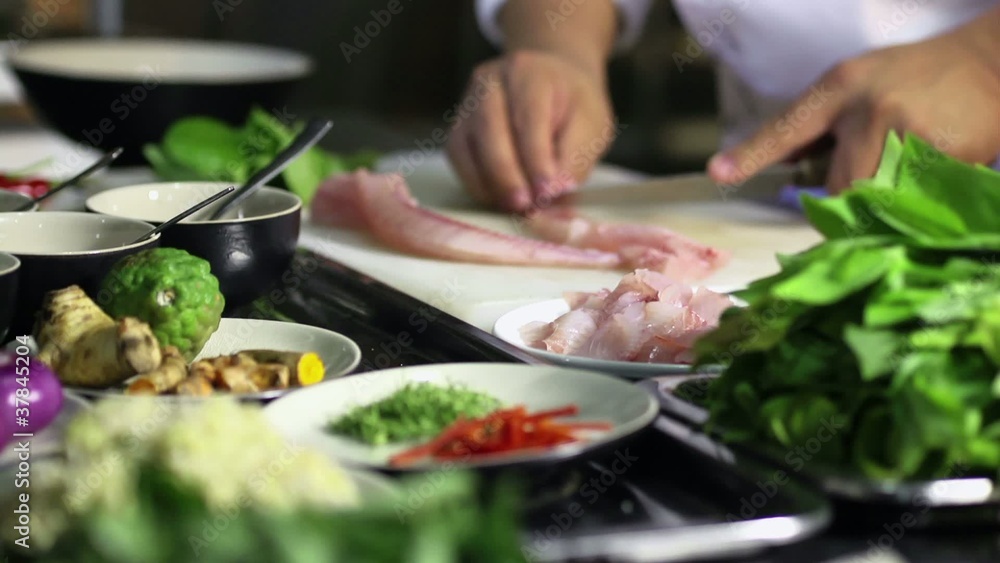 Professional cook working in Asian restaurant kitchen Professional cook working in Asian restaurant kitchen