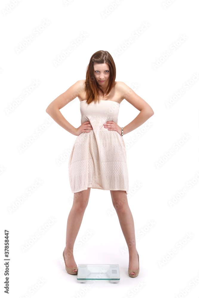 Naklejka premium young woman on a bathroom scale (on white with shadow)