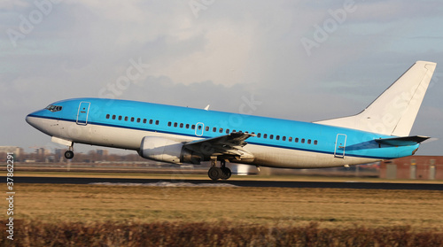 blue plane taking off photo