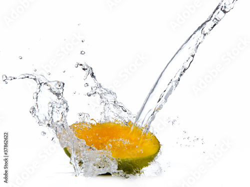 Fresh mango slice in water splash, isolated on white background