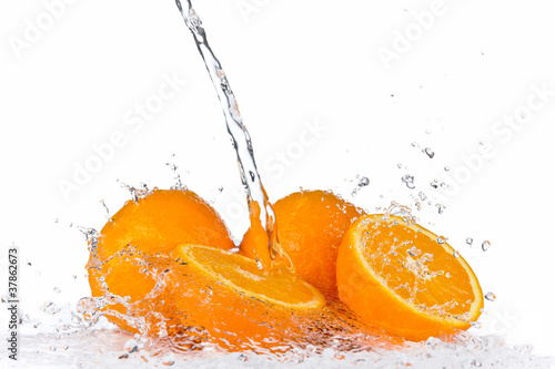 Fototapeta Naklejka Na Ścianę i Meble -  Fresh oranges in water splash, isolated on white background