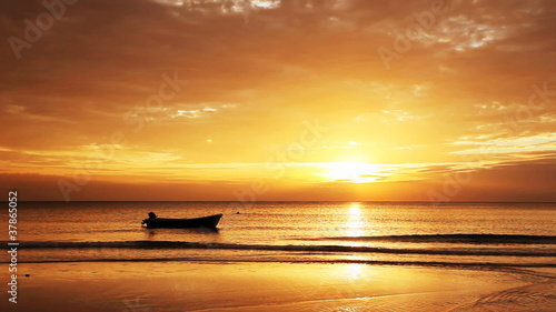 Tropical sunset with fishing ship