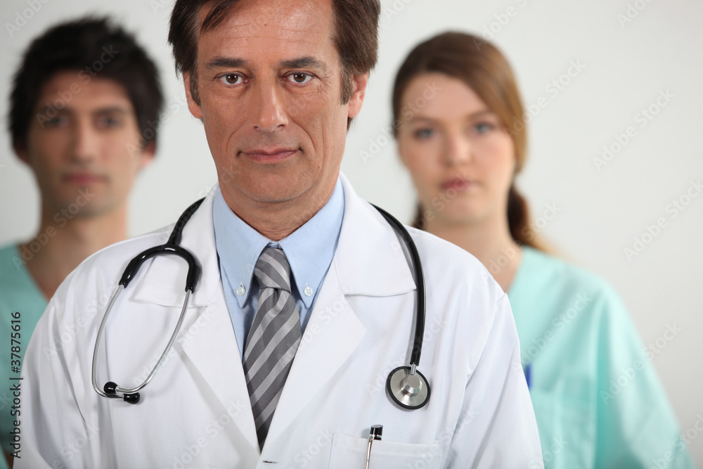 Fototapeta premium A doctor with his two interns