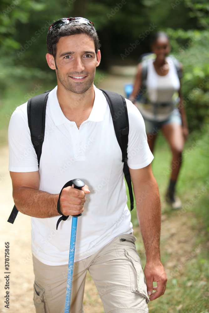 Fototapeta premium Interracial couple hiking in the forest