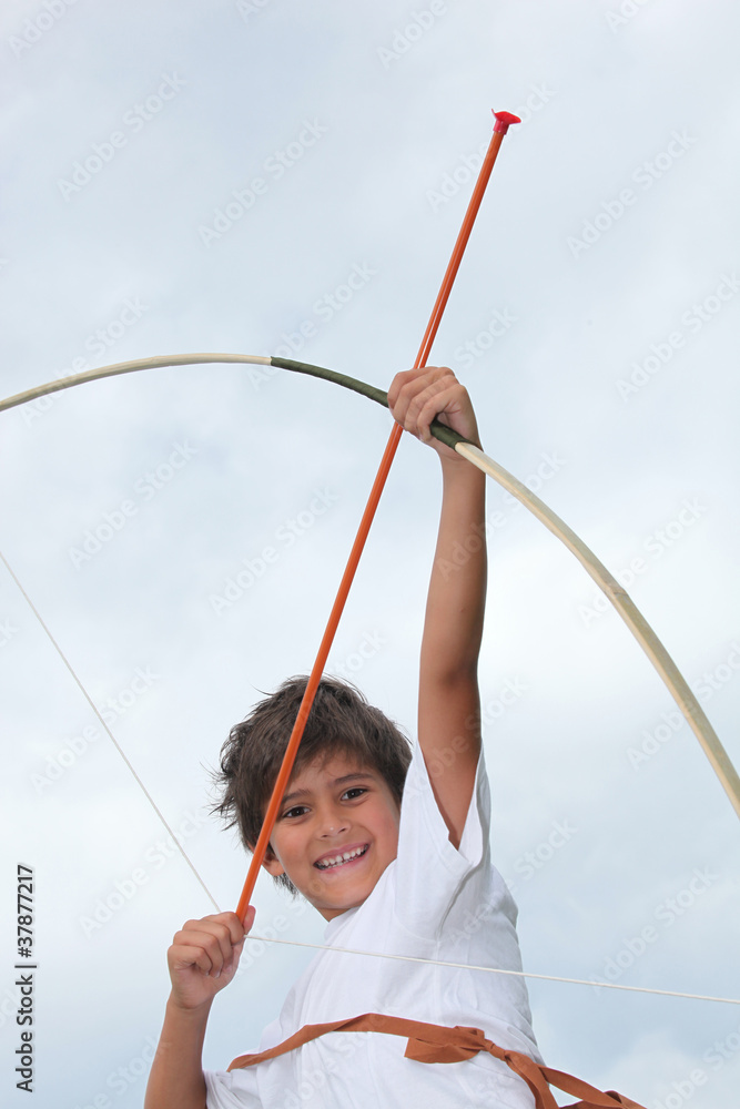 Happy little boy playing with bow and arrow Happy little boy playing with bow and arrow