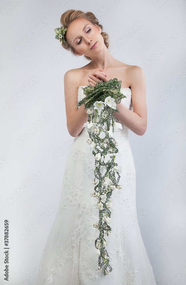 Lovely bride blond with bouquet of fresh tender flowers Lovely bride blond with bouquet of fresh tender flowers