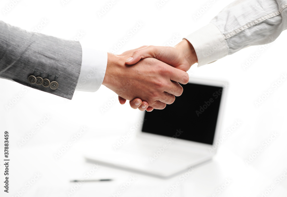 businesspeople shakinghand in office, laptop on background businesspeople shakinghand in office, laptop on background
