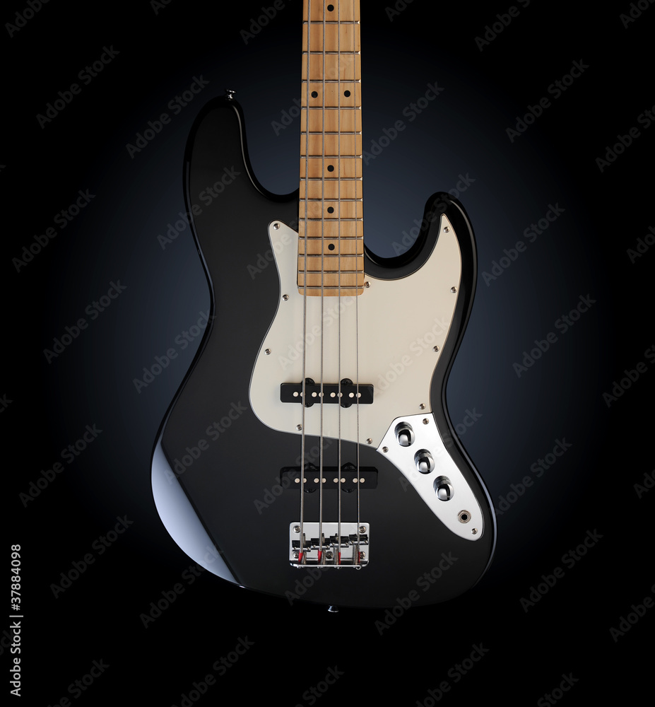 close up of a black electric bass glossy on dark background