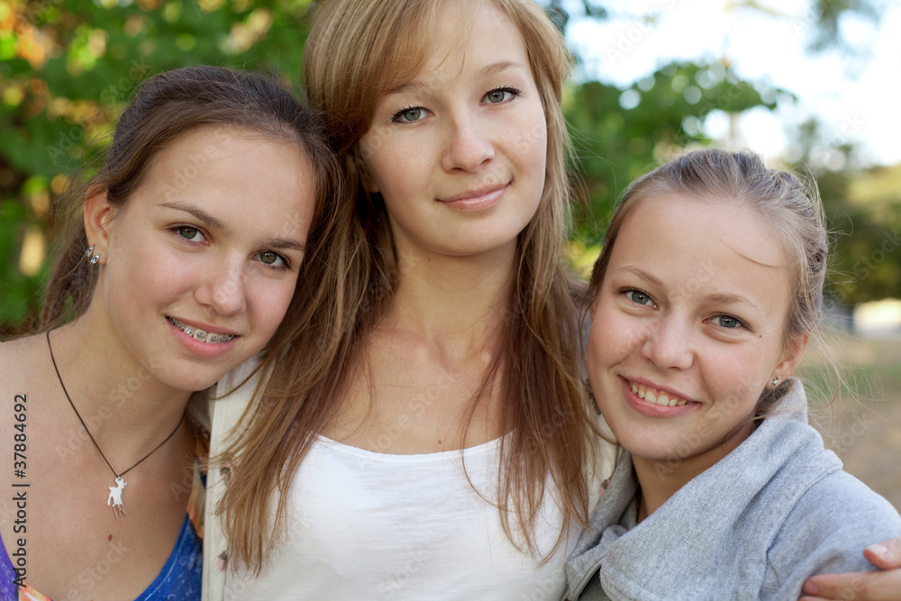Portrait of three pretty student girls in the park Portrait of three pretty student girls in the park