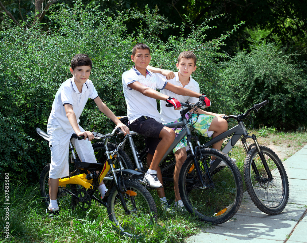 thee teenage friends riding bicycles outdoors thee teenage friends riding bicycles outdoors