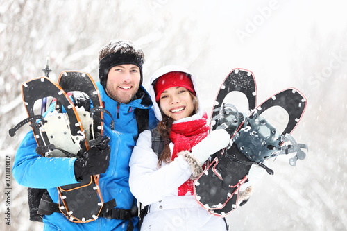 Quadro su tela Winter couple outdoors on snowshoes