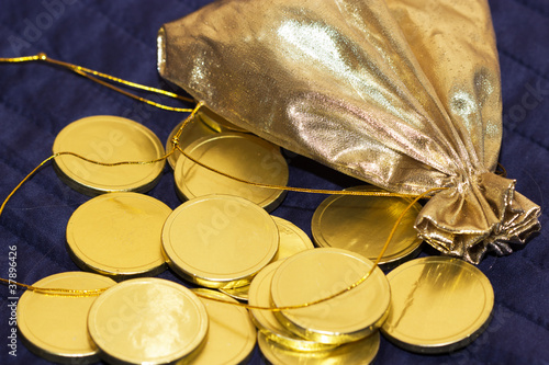 Gold bag with gold chocolate coins photo