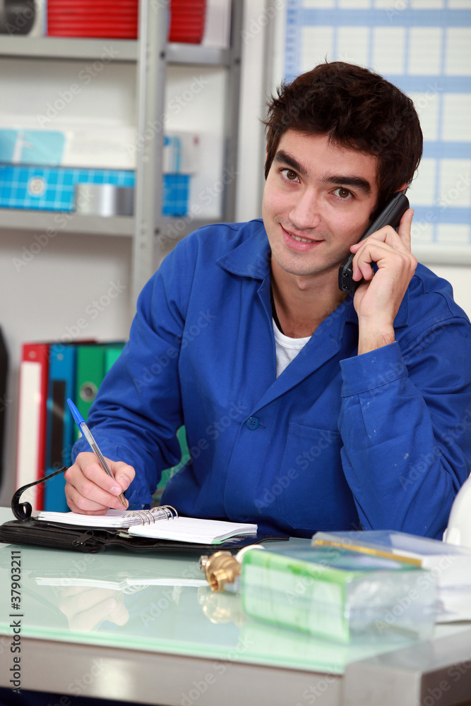 Worker with a phone and diary Worker with a phone and diary