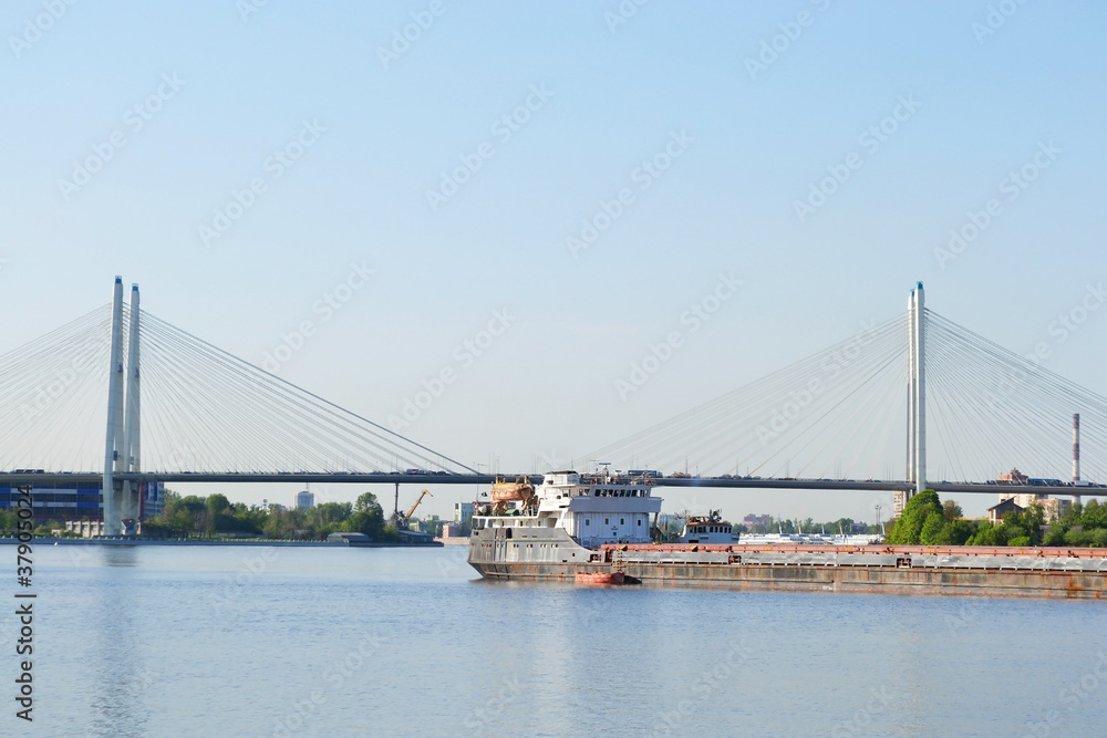 Fototapeta premium Cargo ship and cable-braced bridge