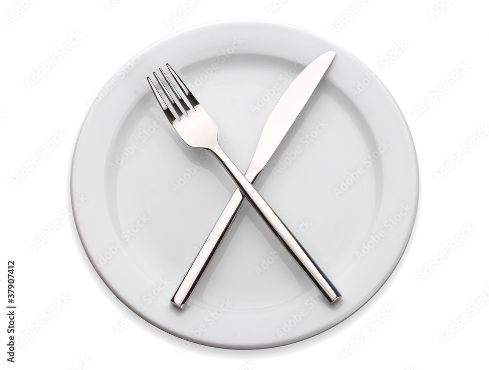 White empty plate with fork and knife isolated on white White empty plate with fork and knife isolated on white