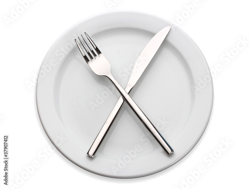 White empty plate with fork and knife isolated on white