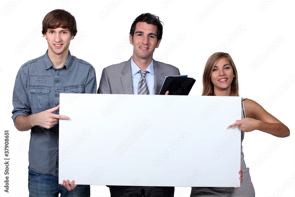 Young people pointing at blank board Young people pointing at blank board