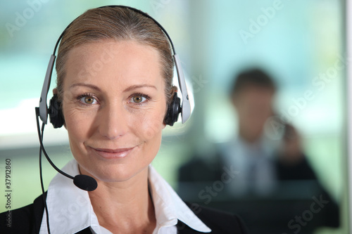 Fotografi Woman smiling with headset