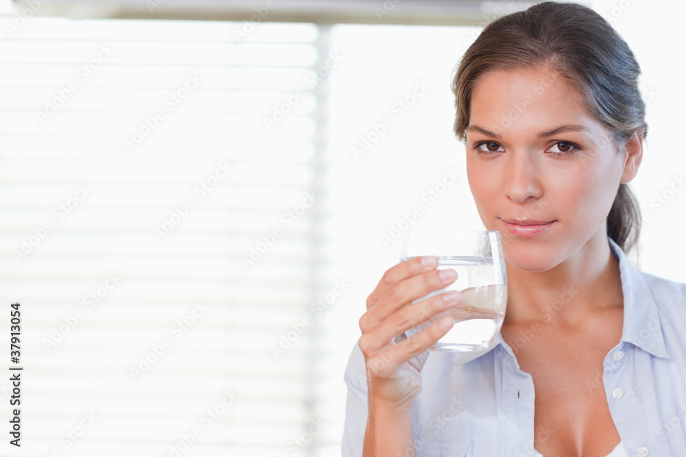Woman drinking a glass of water Woman drinking a glass of water