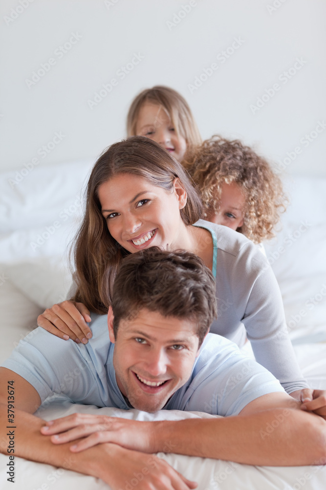 Portrait of a happy family lying on each other