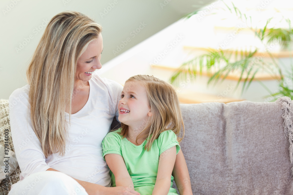 Mother and daughter sitting on sofa Mother and daughter sitting on sofa