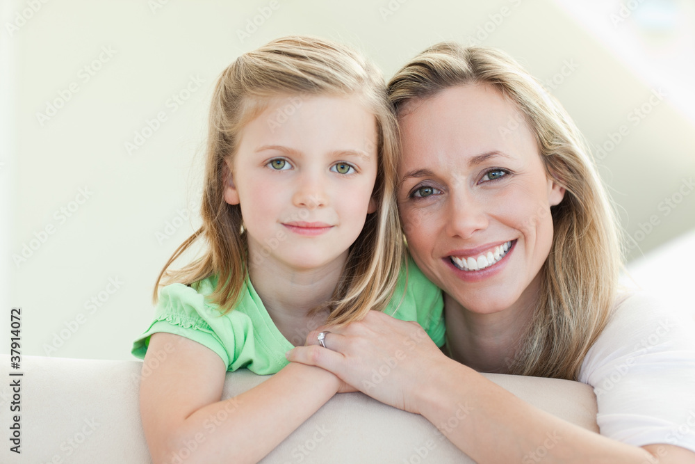 Smiling mother and daughter on the couch Smiling mother and daughter on the couch