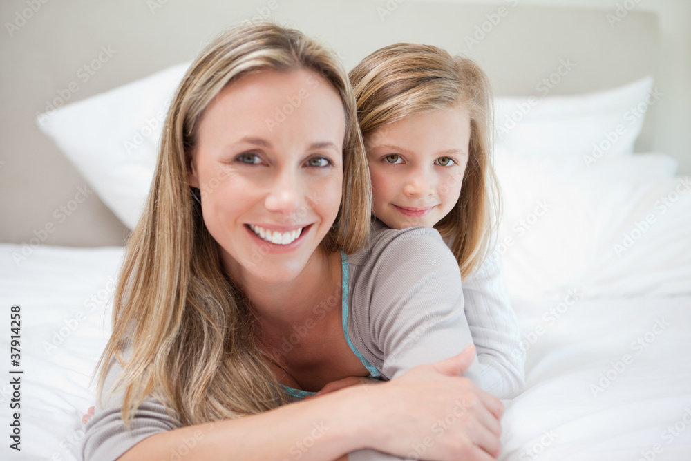 Girl lying on her mothers back