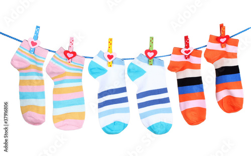 Bright striped socks on line isolated on white