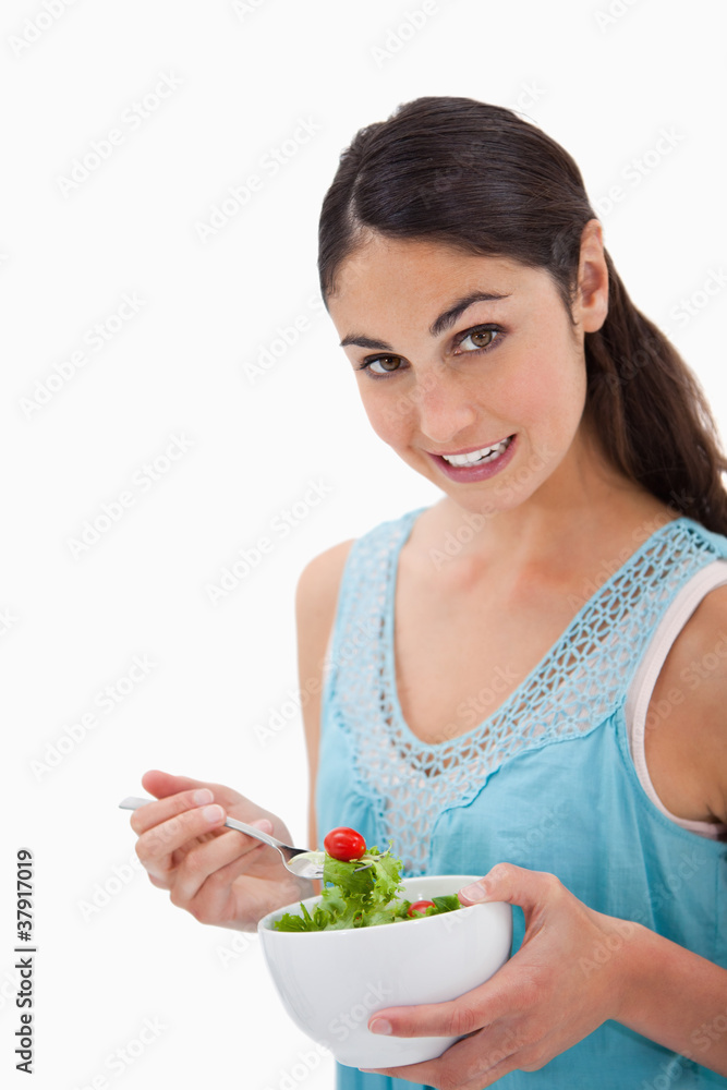 Portrait of a brunette woman eating a salad Portrait of a brunette woman eating a salad