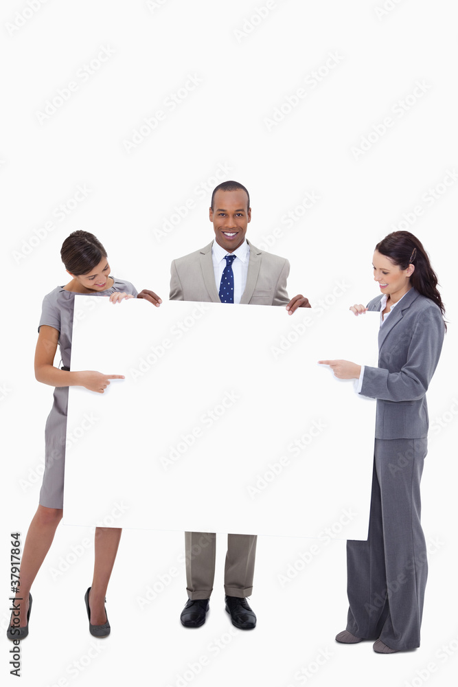 Businesspeople pointing at blank sign in their hands Businesspeople pointing at blank sign in their hands