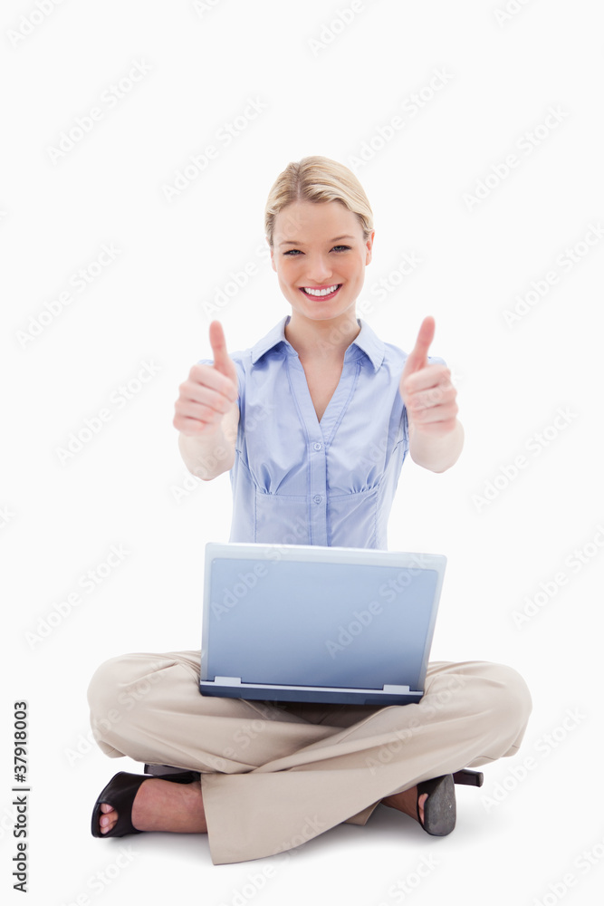 Sitting woman with laptop giving thumbs up Sitting woman with laptop giving thumbs up