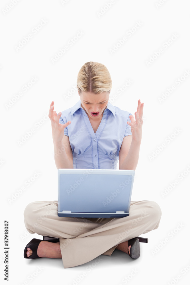 Sitting woman yelling at her laptop Sitting woman yelling at her laptop