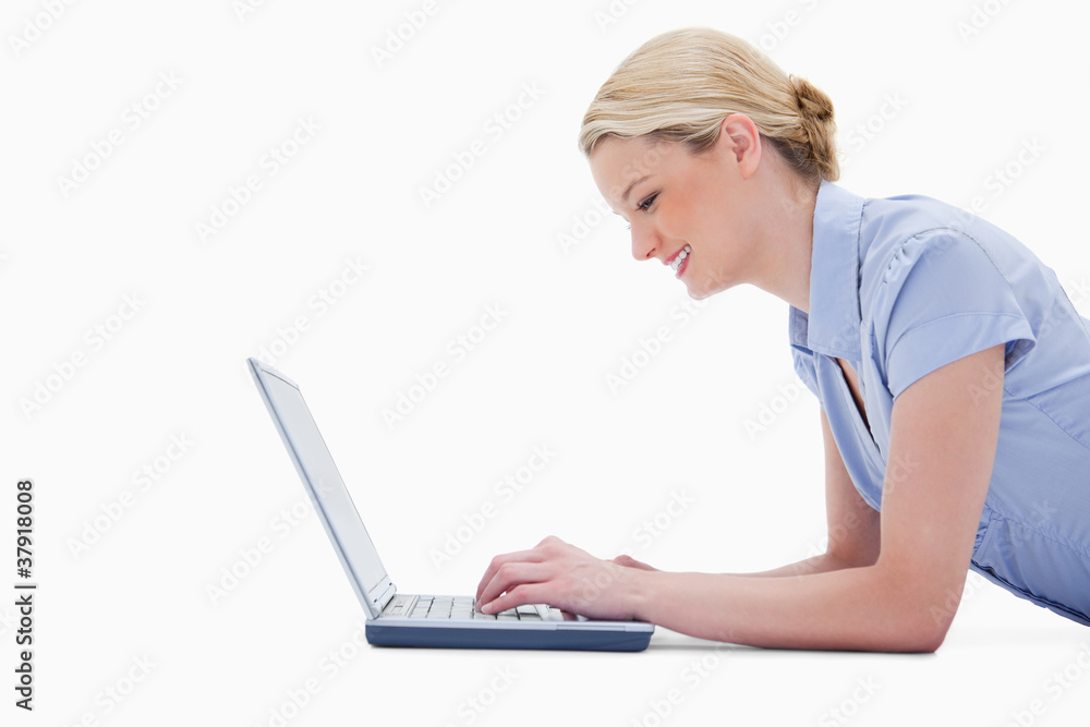 Side view of woman using laptop Side view of woman using laptop