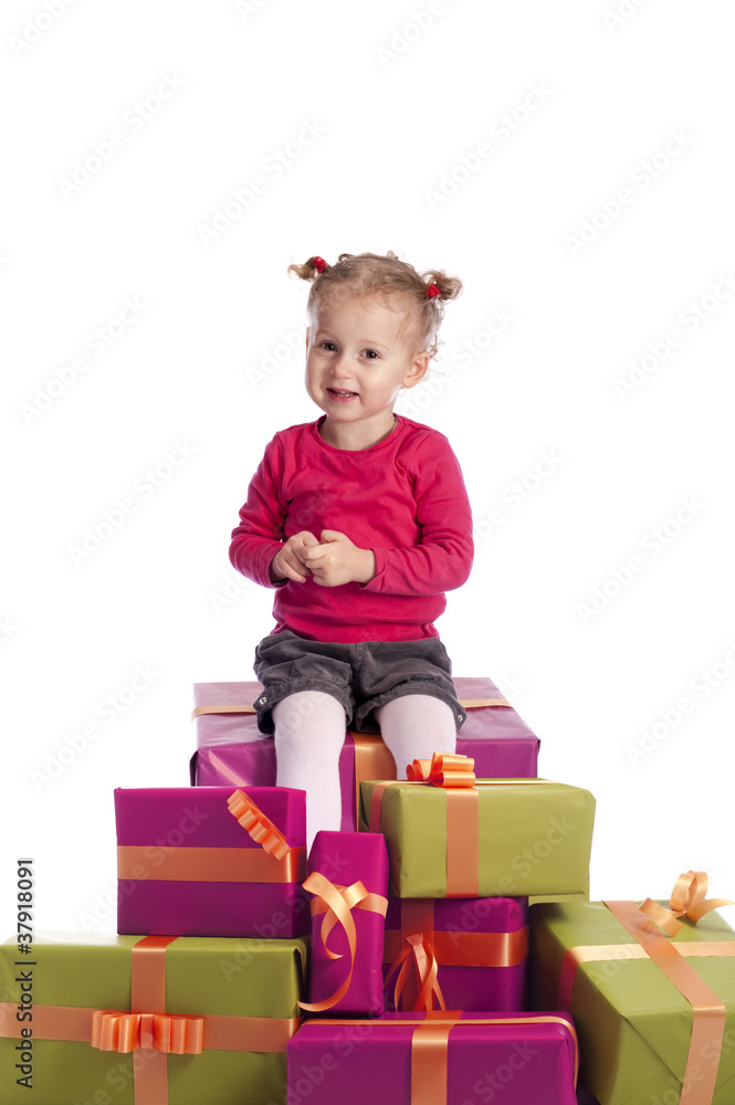 little girl sitting between a lot of presents little girl sitting between a lot of presents