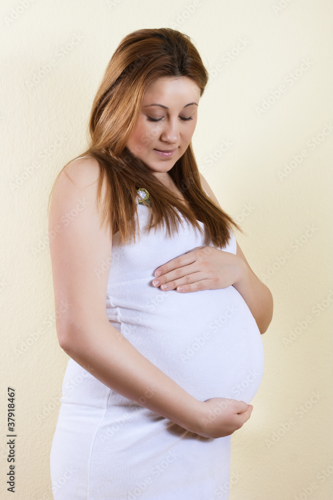 Portrait of beautiful pregnant woman touching her belly Portrait of beautiful pregnant woman touching her belly
