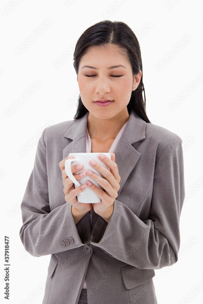 Woman enjoys the smell of her fresh coffee Woman enjoys the smell of her fresh coffee