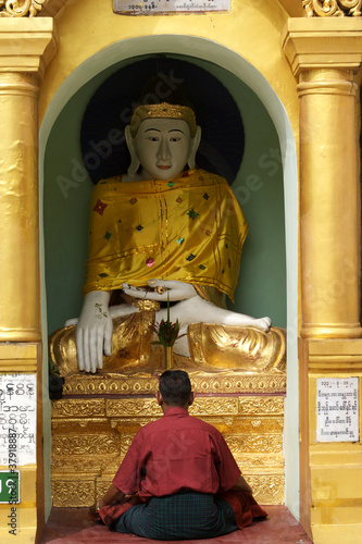 Man praying in the Schwedagon Pagoda in Yangoon - Myanmar