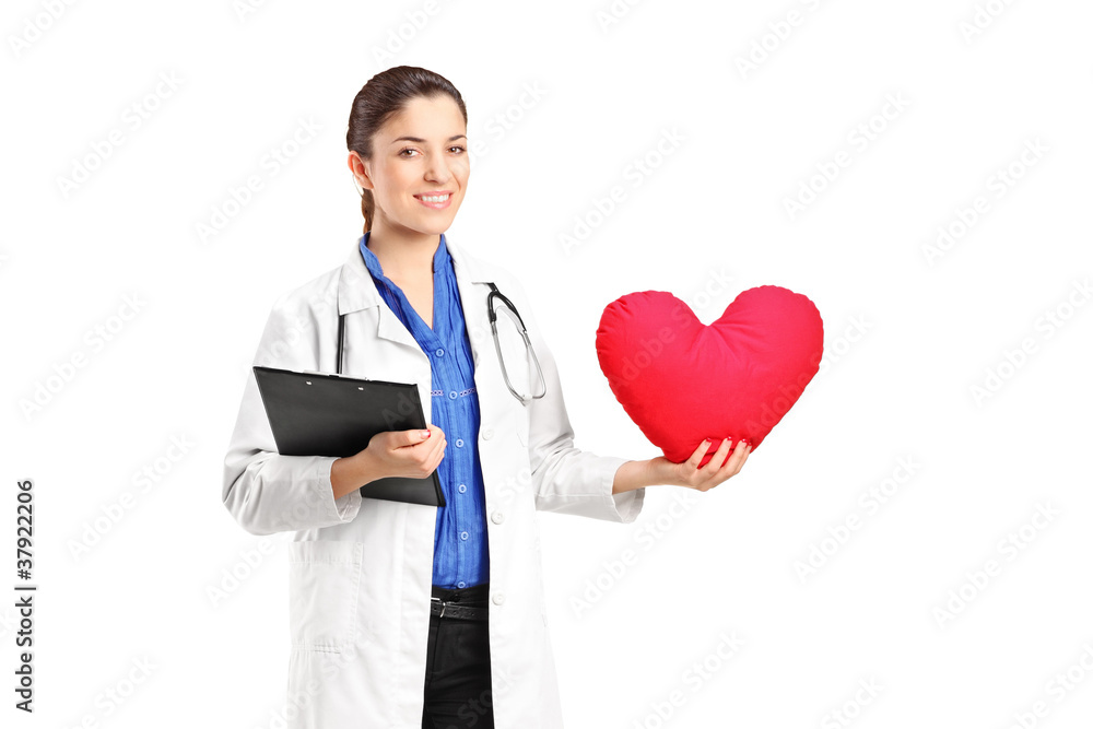 A female doctor holding a red heart