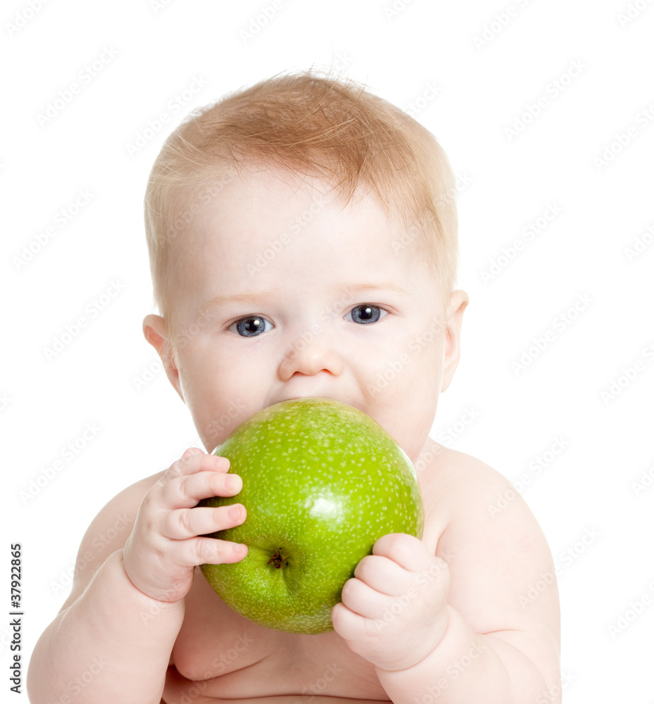 Baby boy holding and eating green apple, isolated on white Baby boy holding and eating green apple, isolated on white
