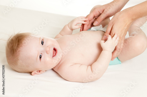 mother massaging her baby girl