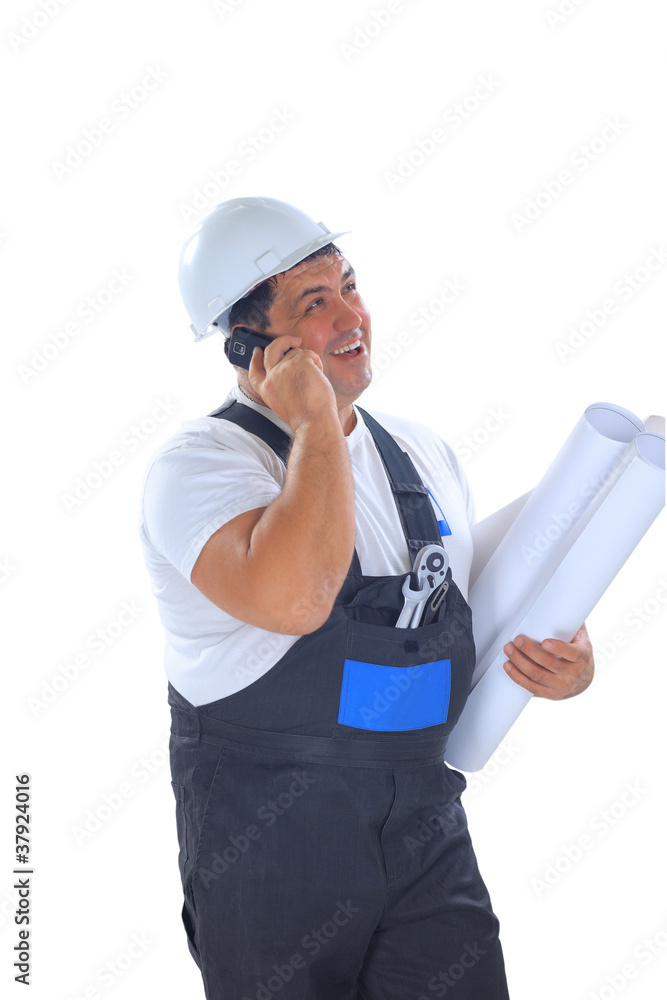 Confident worker with plans talking on mobile phone Confident worker with plans talking on mobile phone