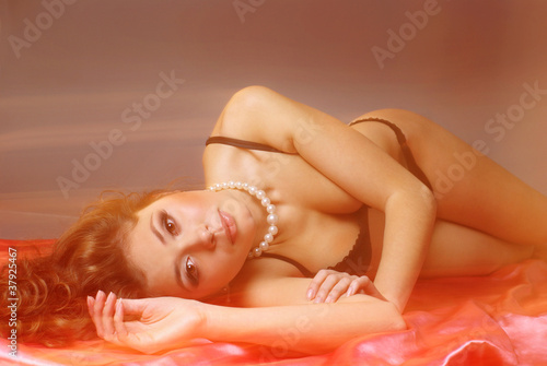 Sensual lingerie model portrait on bed (long exposure)
