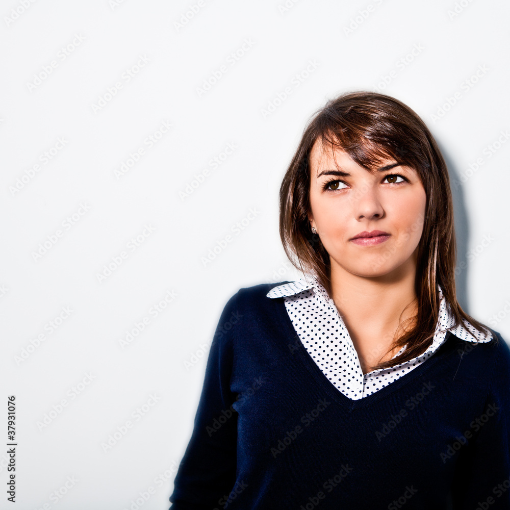 Confident young woman leaning against the wall Confident young woman leaning against the wall