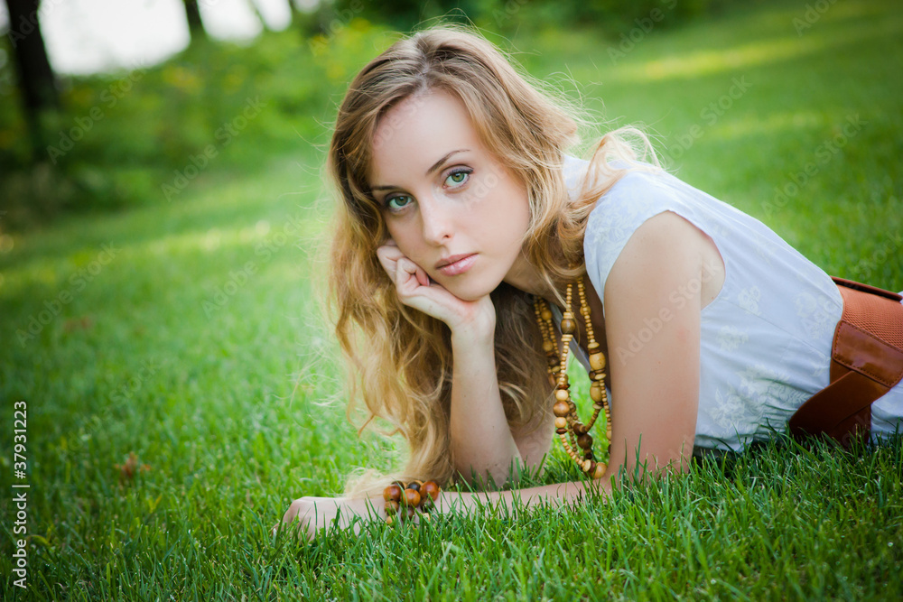 Beautiful girl lies on the grass Beautiful girl lies on the grass