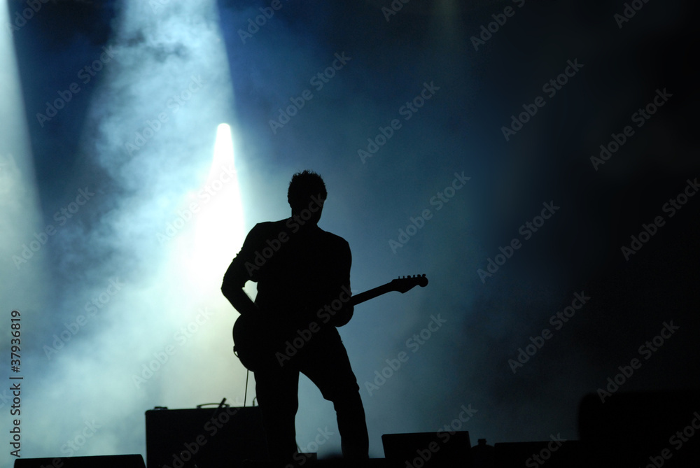 silhouette of guitarist at concert
