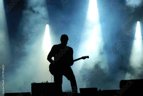 silhouette of guitarist at concert photo