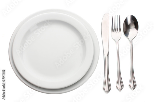 White empty plate with fork, spoon and knife isolated on white