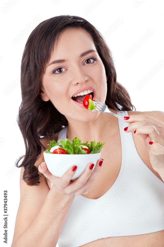 Young girl eating fresh salad