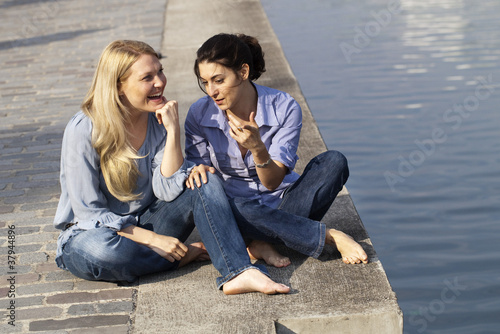 girlfriends chatting next to the water